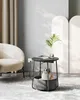A cat sits in a pet bed integrated into a round side table in a living room setting. Náhled obrázku produktu