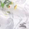 A close-up view of a white sheer curtain with an embossed floral pattern, partially obscuring a background with sunflowers and text. Produktbild-Vorschau