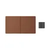 A brown keyboard cover and a small gray accessory are shown on a white background. Anteprima dell’immagine prodotto