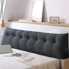 A large, tufted wedge pillow is placed on a bed. Produktbild-Vorschau