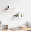 Two white floating shelves mounted on a white wall above a wooden desk. Náhľad obrázku produktu