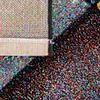 A close-up view of a colorful, textured rug, showing the edge and the pile. Produktbild-Vorschau