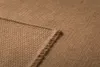 A close-up view of a brown woven blanket with visible stitching and frayed edges. Produktbild-Vorschau