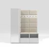A modern white and cream entryway set with a tall cabinet, a padded bench with coat hooks, and shoe storage. Náhled obrázku produktu
