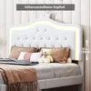 A white upholstered bed with LED lighting and decorative pillows. Produktbild-Vorschau