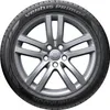 A close-up studio shot of a car tire mounted on a silver alloy wheel. Podgląd zdjęcia produktu