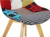 Close-up view of a patchwork chair seat with wooden legs. Produktbild-Vorschau