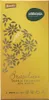 A close-up of a chocolate bar wrapper with decorative floral patterns and text. Produktbild-Vorschau