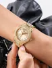 A close-up shot of a gold-colored Guess watch with sparkling details on a person's wrist. Podgląd zdjęcia produktu