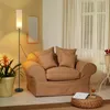 A cozy living room scene featuring a floor lamp and a comfortable armchair. Anteprima dell’immagine prodotto
