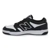 A side view of a black and white New Balance sneaker. Podgląd zdjęcia produktu
