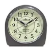 A close-up, front-facing studio shot of an analog alarm clock against a white background. Produktbild-Vorschau