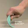 A hand is shown bending a turquoise silicone spatula, demonstrating its flexibility. Anteprima dell’immagine prodotto