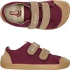 Two views of a pair of burgundy canvas sneakers with tan accents and velcro straps.
