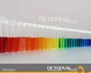 A row of test tubes filled with colorful liquids, arranged in a rainbow gradient. Produktbild-Vorschau