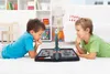 Two young boys playing a board game on the floor in a living room. Produktbild-Vorschau