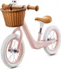 A pink balance bike with a wicker basket and brown handlebars and seat, shown against a white background. Produktbild-Vorschau