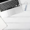 A laptop and a USB hub are placed on a white wooden surface. Produktbild-Vorschau