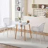 A white round table and two white chairs are set up in a room with a bookshelf and shelves in the background. Voir les images du produit