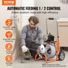 A man is using a pipe cleaning machine in a bathroom. Podgląd zdjęcia produktu