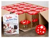 A box of glass jars with red and white mushroom-shaped lids, along with a recipe book. Produktbild-Vorschau