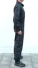 A person wearing a black jumpsuit, shown from the side against a white background. Náhled obrázku produktu