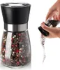 A pepper mill is shown on the left, and a hand is shown grinding pepper from a second pepper mill on the right. Produktbild-Vorschau