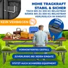 A picnic table set up outdoors with food and drinks on it, and a person sitting at the table. Produktbild-Vorschau