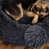 A dog sleeping in a plush dog bed. Anteprima dell’immagine prodotto