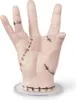A prosthetic hand with stitches, standing on a clear base. Anteprima dell’immagine prodotto