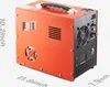A product shot of an orange and black air compressor with dimensions indicated. Produktbild-Vorschau