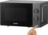 A hand is pressing a button on a Gorenje microwave. Anteprima dell’immagine prodotto