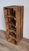 A wooden shelf unit made of crates, standing against a white wall and on a wooden floor. Produktbild-Vorschau