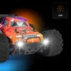 A close-up shot of an RC off-road car with its headlights on, set against a dark background with orange and blue lighting effects. Anteprima dell’immagine prodotto
