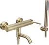 A gold-colored bathtub faucet with a handheld showerhead. Produktbild-Vorschau