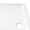 A close-up, angled view of a white shower tray with a textured surface and a drain hole. Náhľad obrázku produktu