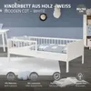 A white wooden cot with blue bedding is shown in a child's room setting, with decorative elements on the wall and floor. Produktbild-Vorschau