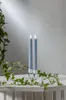 Two LED candles in glass holders on a table with ivy. Produktbild-Vorschau