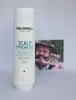 A bottle of Goldwell shampoo is placed in front of a small framed picture of a man. Anteprima dell’immagine prodotto