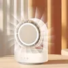 A modern desk fan with a built-in light and cosmetic mirror, displayed on a table with a soft background. Produktbild-Vorschau