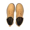 A top-down view of a pair of tan Puma boots. Podgląd zdjęcia produktu