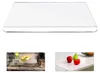 A clear, rectangular cutting board with rounded edges, shown from a slightly elevated angle. Produktbild-Vorschau