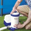 A person is shown interacting with a pool filter pump next to a blue swimming pool. Voir les images du produit