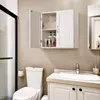 A white wall-mounted cabinet with two doors is shown open, revealing folded towels and toiletries on shelves. Below it is a toilet and a sink with a faucet. Produktbild-Vorschau