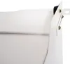 A close-up view of the corner of a white washing machine pedestal with mounting hardware. Náhľad obrázku produktu