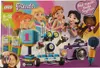 The image shows the LEGO Friends Friendship Box packaging, featuring several LEGO Friends characters and various LEGO models like a robot, a camera, and walkie-talkies. Voir les images du produit