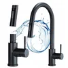 A black kitchen faucet with water splashing around it. Produktbild-Vorschau