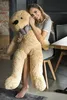 A woman is sitting on a chair holding a large teddy bear. Náhľad obrázku produktu