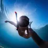 A person snorkeling underwater with the sun shining through the water. Náhľad obrázku produktu