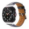 A close-up studio shot of a smartwatch with a leather band. Náhled obrázku produktu